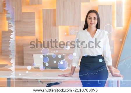 Portrait of attractive smiling businesswoman in formal wear thinking how to optimize trading strategy at corporate finance fund. Forex chart hologram over modern office background