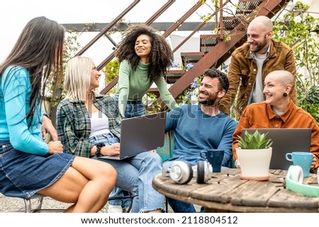 Digital native group of friends sharing content and ideas in team work meeting,  tech life style concept with guys and girls having fun, telecommuting an remote work place concepts, young creative Royalty-Free Stock Photo #2118804512