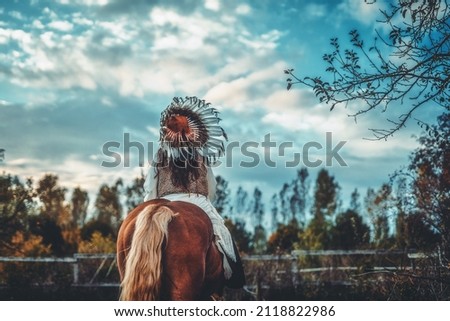 Shaman woman in landscape with her horse.