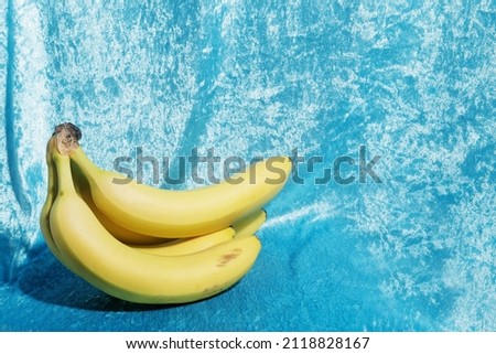 
yellow bananas on light blue fabric