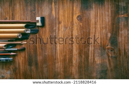 Top view of a wooden table with set of stationery utensils. Traditional Islamic art. Design mockup for decoration needs.