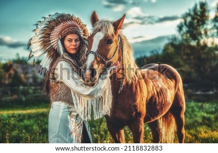 Shaman woman in landscape with her horse.