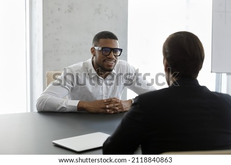 Happy confident African business leader meeting with employee, partner, discussing project. Employer interviewing job candidate. Client consulting lawyer, financial broker, banker for advice Royalty-Free Stock Photo #2118840863