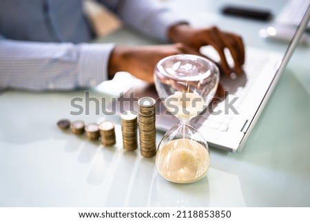 Increasing Money Coin Stack Concept. Hourglass And Time Royalty-Free Stock Photo #2118853850