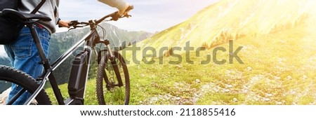 E Bike Bicycle In Austria. Man In Helmet With Mountain Ebike