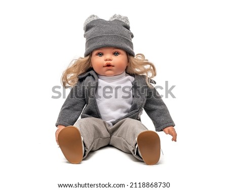 Little plastic doll baby girl isolated on white background. Royalty-Free Stock Photo #2118868730