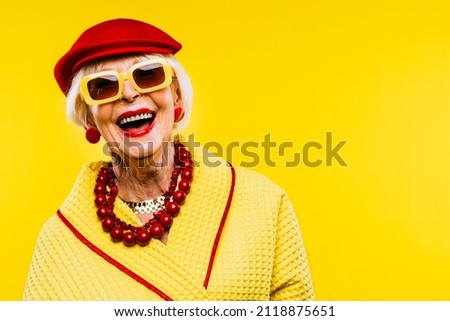 Happy and funny cool old lady with fashionable clothes portrait on colored background - Youthful grandmother with extravagant style, concepts about lifestyle, seniority and elderly people Royalty-Free Stock Photo #2118875651