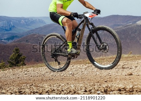 athlete cyclist riding uphill on mountain bike