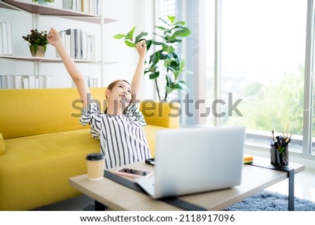 A photo of a bright Asian business woman working at home in the room. The idea is Work form Home Finance Marketing Bright Portrait Simple