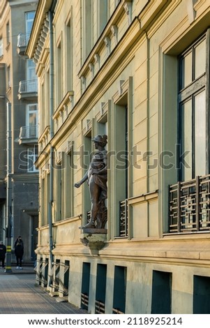 View of the statue of God Mercurius on facade of building in Liepaja, Latvia. Royalty-Free Stock Photo #2118925214