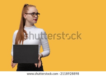 a teacher girl with a positive smile and long hair poses with papers