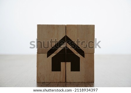 Home icons or symbol on a wooden cubes over the white background. property and insurance banner