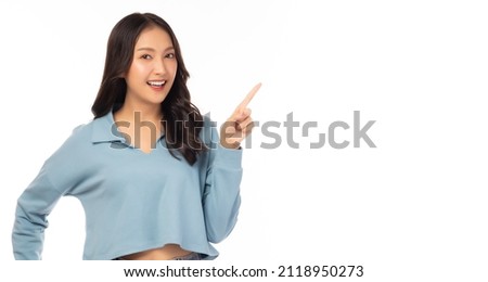 Beautiful young Asian woman pointing up to copy space and looking at camera with smile face and happiness Pretty girl act like a satisfied product, use for advertising with white background copy space Royalty-Free Stock Photo #2118950273