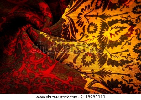 Silk brown with floral print and rhombuses. Soft fabric, glossy texture background, satin background, fabric luxury work, elegant pattern, colorful abstract, colorful velvet, macro shredded.