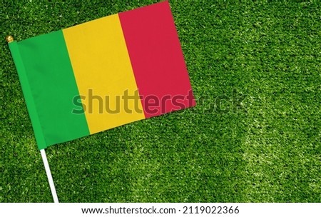 Close-up of Mali flag against closed up view of grass