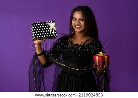 Portrait of young happy smiling woman or Girl holding gift box.