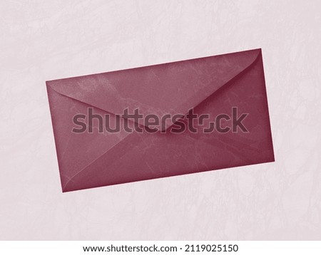 Elegant red envelope on pinkish background. Delicate marble pattern on kraft paper. Vintage style.