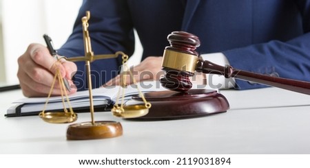 Lawyer working with contract papers and wooden gavel on tabel in courtroom. justice and law ,attorney, court judge concept.