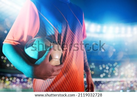 Soccer player ready to play with soccerball at the stadium