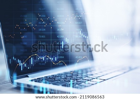 Close up of laptop computer with abstract glowing big data forex candlestick chart on blurry background. Trade, technology, investment and analysis concept. Double exposure