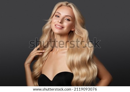 Beautiful blond girl with a perfectly curls hair, and classic make-up. Beauty face and hair. Royalty-Free Stock Photo #2119093076