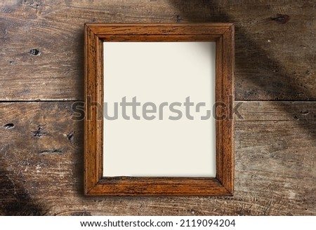 empty wooden frame on old rustic wall