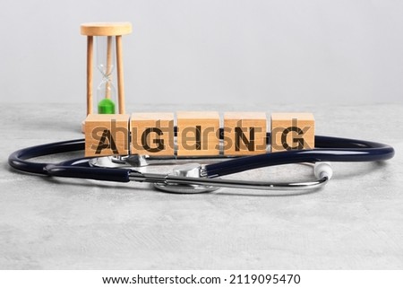 pulse word written on wooden blocks, stethoscope and hourglass on light gray background, medical concept