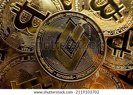 Cryptocurrency Dash tokens from above on bitcoins background.