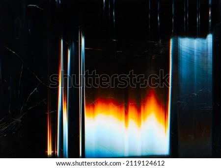 Glitch overlay. Broken screen texture. Fractured monitor. Blue orange white glow artifacts dust scratches noise on dark black distorted rough surface abstract wallpaper. Royalty-Free Stock Photo #2119124612