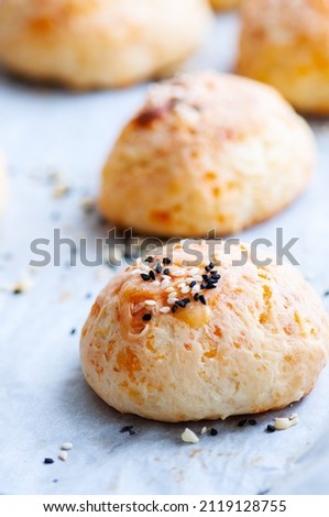 Homemade cheesy dinner rolls with sesame seeds.