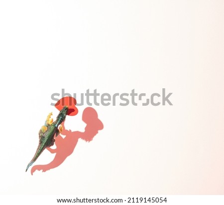Dinosaur with red heart on white background. Minimal romantic concept. Symbol of love. Valentine's day, February 14th