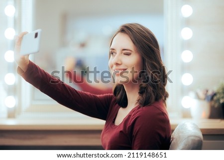 
Happy Customer Taking a Selfie at Hair Salon. Woman with boosted self-confidence after beauty make-over in professional salon

