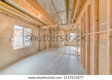 Unfinished basement with wood framing and insulated walls Royalty-Free Stock Photo #2119153877