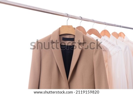 Hanger with male formal suit and four white shirt 