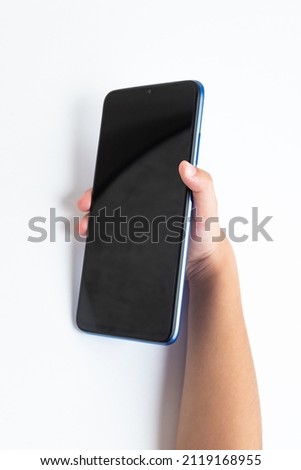 Child holding cellphone over white background