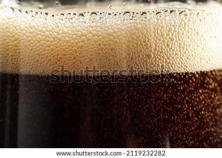 Glass of refreshing soda drink as background, closeup