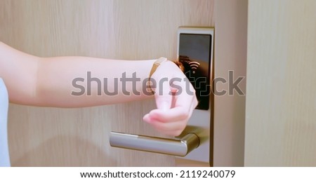 smart home concept - close up of asian woman opens electronic lock by NFC smartwatch Royalty-Free Stock Photo #2119240079