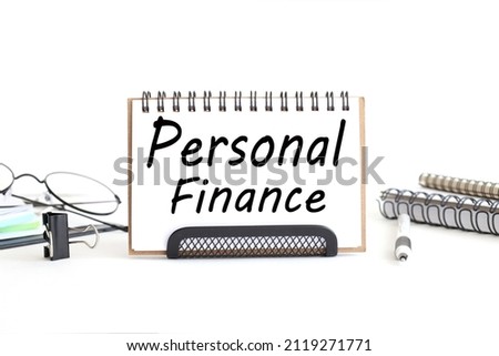Personal Finance, text on white open notebook on white background