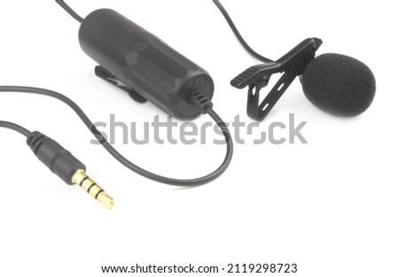 Black lavalier microphone isolated on white background close up