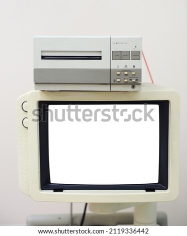Old ultrasonic monitor with white screen and printer.