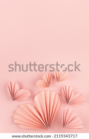 Sweet love Valentine day background with pink paper hearts of asian fans in modern fashion style fly on cute soft light pastel pink backdrop, footer border, copy space, top view, vertical.