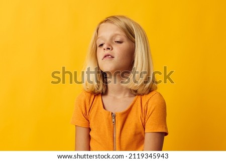 little blonde girl holding her head emotions surprise