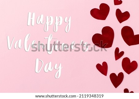 Happy Valentines Day greeting card. Happy Valentine's Day text on stylish red hearts on pink background. Be my Valentine. Love concept