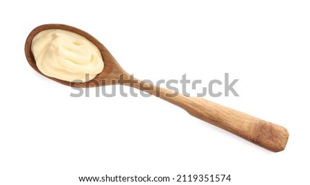 Wooden spoon with tasty mayonnaise isolated on white, top view