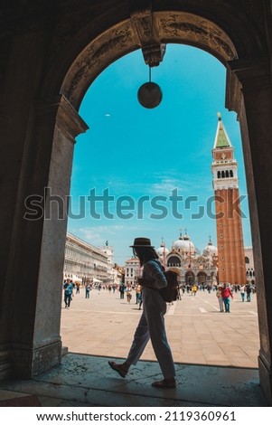 woman in front of bell tower of san marks square at venice italy summer time silhouette