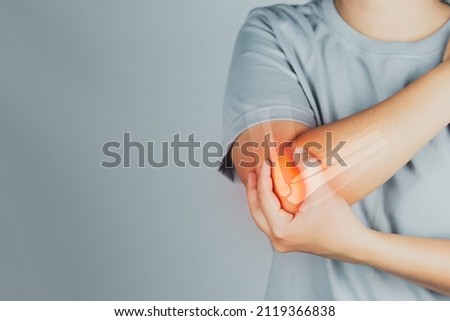 Health concept, person with elbow pain, woman holding hands on elbow with pain, virtual bone image on elbow Royalty-Free Stock Photo #2119366838