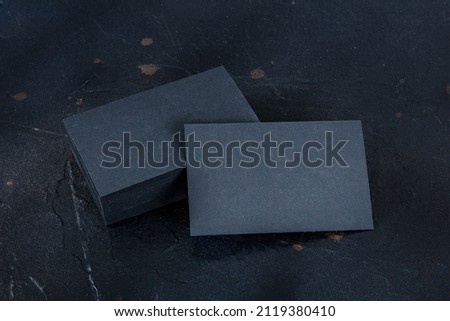 Black business card mockup on a dark background, a template for design presentation, thick cardboard