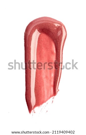 Lipstick swatch isolated on white background. Red lip gloss swipe