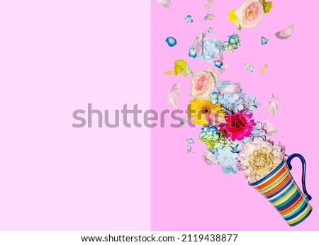 fresh flowers flying out from a tea cup isolated over color clock pint and purple background, spring or summer concept, nature in bloom. High quality photo