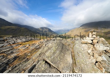 Vews of Lingmell and Great Gable from the mountain summit cairn of Seathwaite Fell in the English Lake District. Royalty-Free Stock Photo #2119474172